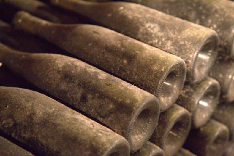 Dusty Bottles in Cellar of Xavier Durand